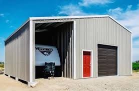 RV Camper parked inside a brown metal storage structure 